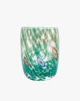 A handcrafted round Murano tumbler with a tapered silhouette, featuring green color with white patterns and multicolored details.