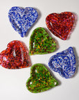 Six heart-shaped glass bowls in assorted vibrant colors, including blue, red, and green with marbled patterns, arranged on a light gray background.