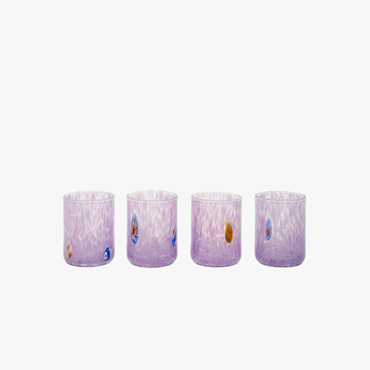 A set of four hand-blown purple Murano shot glasses with unique patterns and tiny murrina details.