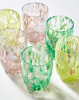 Six decorative drinking glasses with a textured, hammered glass finish in various pastel colors including green, pink, and yellow, arranged on a white surface with soft shadows.
